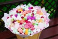 Flowers, fruit bouquet, pink carnation, marshmallows, macaroons, nature Royalty Free Stock Photo