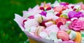 Flowers, fruit bouquet, pink carnation, marshmallows, macaroons, nature Royalty Free Stock Photo