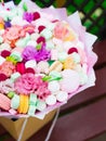 Flowers, fruit bouquet, pink carnation, marshmallows, macaroons, nature Royalty Free Stock Photo