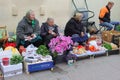 Elderly women sell Cosmos flowers and fruits at the Kalvariju market in the Old town of Vilnius, Lithuania Royalty Free Stock Photo