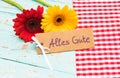 Flowers and gift card with german text, Alles Gute, means best wishes for Birthday or Anniversary