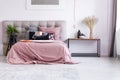Pastel pink bedroom with plant