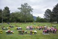 Flowers on Graveside in a cemetary with trees in background