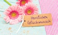 Flowers and greeting card card with german text, Herzlichen Glueckwunsch, means congratulation