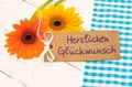 Flowers and greeting card with german text, Herzlichen Glueckwunsch, means congratulation