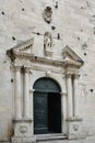 Flowers growing luxuriantly over the main entrance to church in Old Omis city, Dalmatia, Croatia Royalty Free Stock Photo