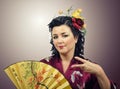 Flowers haired kimono woman doing cool hand gesture