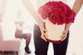 Flowers in the haMan gives bouquet of flowers roses gift in box to girl in love t box