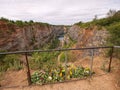 Flowers at handrail above closed mine. Memory to died victims