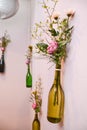 Flowers in hanging bottles Royalty Free Stock Photo