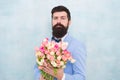 Flowers for her. Man bearded suit bow tie hold tulips bouquet. Gentleman making romantic surprise for her. Flowers Royalty Free Stock Photo