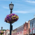 flowers on a lamp post, Canadian flags on building