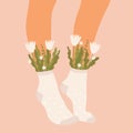 Flowers and leaves in socks on a pair of female legs. Summer bouquet aesthetic. Blossoms and high socks