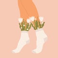 Flowers and leaves in socks on a pair of female legs. Summer bouquet aesthetic. Blossoms and high socks. Modern floral