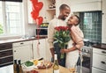 Flowers, love and valentines day with a black couple in the kitchen for a romantic celebration together. Food, gift or