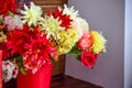 Flowers made of artificial materials in a pink bucket