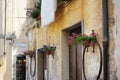Flowers on narrow old streets of the famous Pitigliano town. Beautiful italian towns and villages. Etruscan heritage, Grosseto, Royalty Free Stock Photo