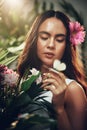 Flowers, natural and woman in a garden during spring for peace, zen and beauty with plants. Summer, gardening and nature Royalty Free Stock Photo