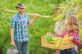 Flowers need my care. little girl and happy man dad. earth day. spring village country. family farm. ecology. Gardening Royalty Free Stock Photo