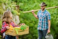 Flowers need my care. little girl and happy man dad. earth day. spring village country. family farm. ecology. Gardening Royalty Free Stock Photo