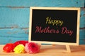 Flowers next to blackboard. happy mother's day concept
