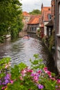 Flowers overlooking a canal in Bruge with a boat