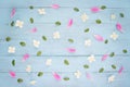 Flowers pattern made of pink paeonia petals and white jasmine flowers.Floral abstract. Blue wooden background. Flat lay, top