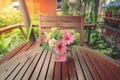 Flowers in a pot on a wooden table with blur background Royalty Free Stock Photo