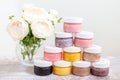 Flowers and a pyrmid of body scrub jars Royalty Free Stock Photo