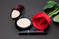 Flowers rose,Powder and lipstick brush uses lips on black backg