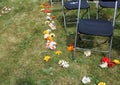 Flowers scatted on a wedding aisle in a lawn