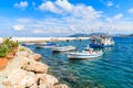 Flowers on shore with fishing boats in Kokkari port, Samos island, Greece Royalty Free Stock Photo