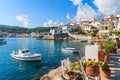 Flowers on shore with fishing boats in Kokkari port, Samos island, Greece Royalty Free Stock Photo