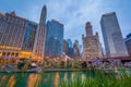 Flowers and skyscrapers along the Chicago River at night in Chicago, Illinois