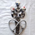 Flowers for St. Valentine`s Day from the plumber in love heart from water hoses in a metal braid, a sanitary adjustable spanner,