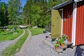 Flowers on stairs infront of a red wooden cabin