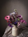 Flowers Still life. Beautiful colorful flowers in vase on moody background. Stylish artistic composition of lathyrus, anemone, Royalty Free Stock Photo