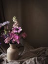 Flowers Still life. Beautiful colorful flowers in vase on moody background. Stylish artistic composition of lathyrus, anemone, Royalty Free Stock Photo