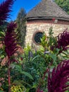 Flowers by stone building in botanical garden Royalty Free Stock Photo