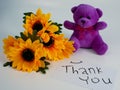 flowers and teddy bear with handwritten thank you paper notes