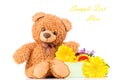Flowers and a teddy bear