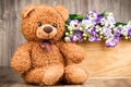 Flowers and a teddy bear
