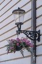 Flowers under a wall lamp at Ljubljana street