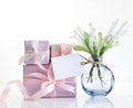 Flowers in vase and gift box on white background. Mother\'s day.Women\'s day.Present with tag empty copy space Royalty Free Stock Photo