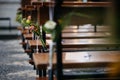flowers in vases sitting on wooden benches in an empty church Royalty Free Stock Photo