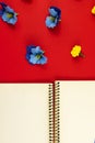 Flowers vertical composition, flat design, blank notebook with place for text on a red background, top view Royalty Free Stock Photo