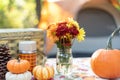 Flowers and vintage picnic items on a table at a campsite