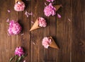 Flowers in a waffle cone. Pink carnations. Flowers on a wooden background. Copyspace. Royalty Free Stock Photo