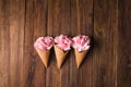 Flowers in a waffle cone. Pink carnations. Flowers on a wooden background Royalty Free Stock Photo