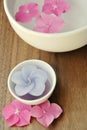 Flowers in a water bowl with a candle for aromatherapy